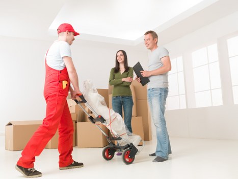 Removal team loading furniture from a Victorian conversion